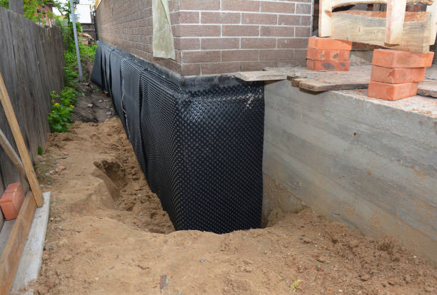SJ Waterproofing Pros technician performing targeted Waterproofing assessment in Sand Lake, MI